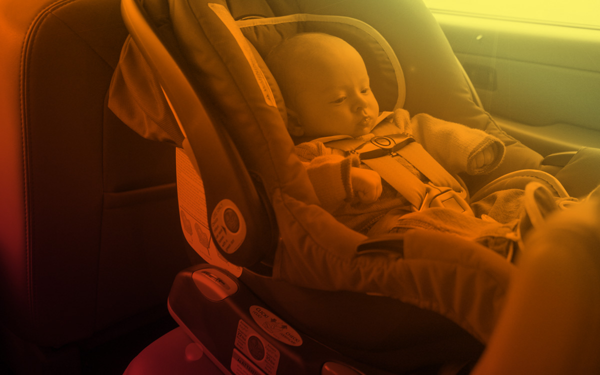 Child in car seat inside hot car